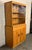 Mid-Century Modern china cabinet by Heywood-Wakefield, circa 1960s. Featuring a distinctive "Champagne" finish, the...