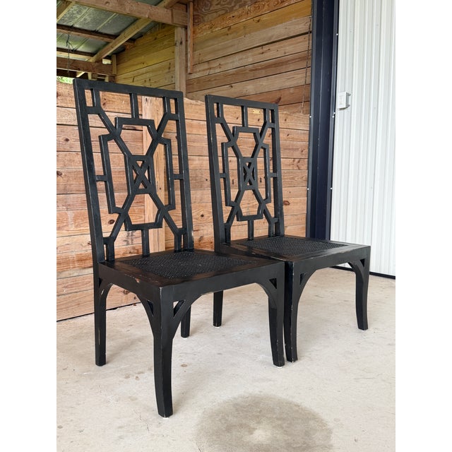 A striking pair of dining side chairs by Guildmaster featuring tall geometric Chinoiserie-style backs and inset woven cane...