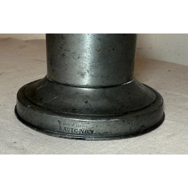 This antique 18th century pewter candlestick from Avignon, France is a beautifully crafted handmade piece that adds a...