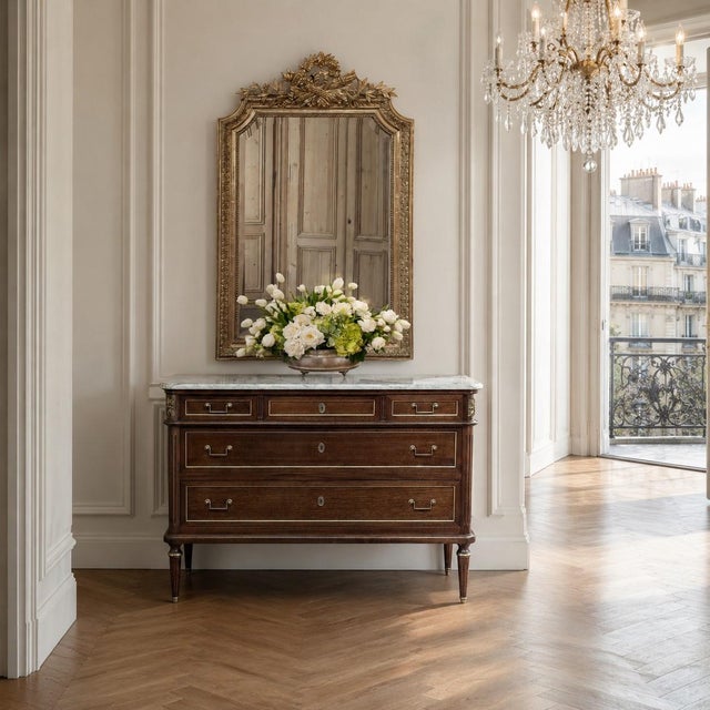 A Louis XVI mirror from 19th century France, retaining its original gold leaf water gilding and a warm, time softened...