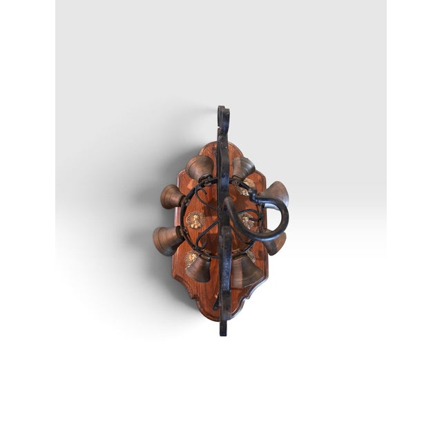 A wonderfully unusual vintage mechanical eight-bell door bell featuring a hand-worked wrought iron frame mounted to a...