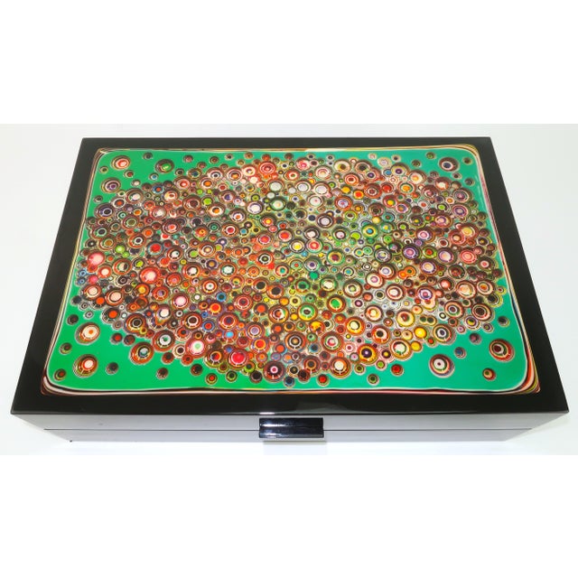 Get a good dose of form and function with an op art lacquered wood box displaying a representation of one of German...