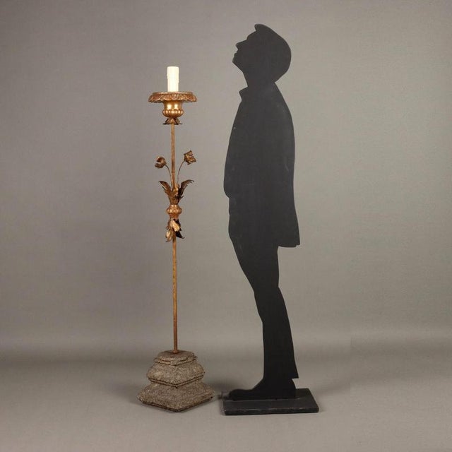 Iron and sheet metal candelabra worked with gilded leaves and carved wood, base with granite capital. Italy, early 20th...