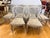 A beautiful and cohesive set of six dining chairs in a distressed silver-grey painted finish. The carved wheat-sheaf splat...