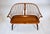 An early 20th C. hand crafted bench designed to offer comfort in a configuration for two. Features include bent wood arms,...