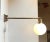 Side to side adjustable wall lamp composed of a solid heavy stock brass 'body' installed with a opaline ball shade. It was...