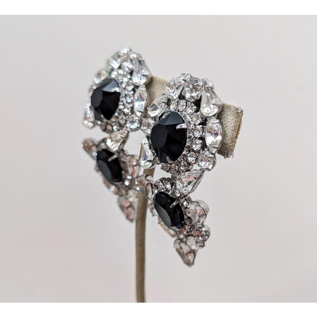 Rare 1990s rhodium plated round and pear shaped faux-onyx surrounded by round, pear and marquise clear rhinestones two...
