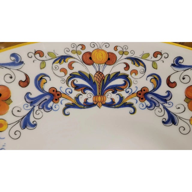 A radiant example of mid-century ceramic artistry, this hand-painted plate bursts with symmetrical florals in vivid...
