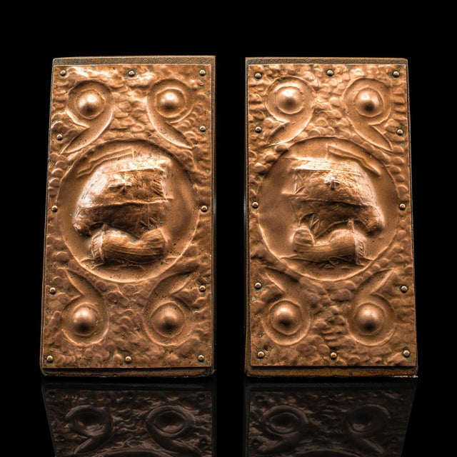 This is a pair of antique maritime bookends. A Continental, copper plated oak book rest in Arts & Crafts taste, dating to...