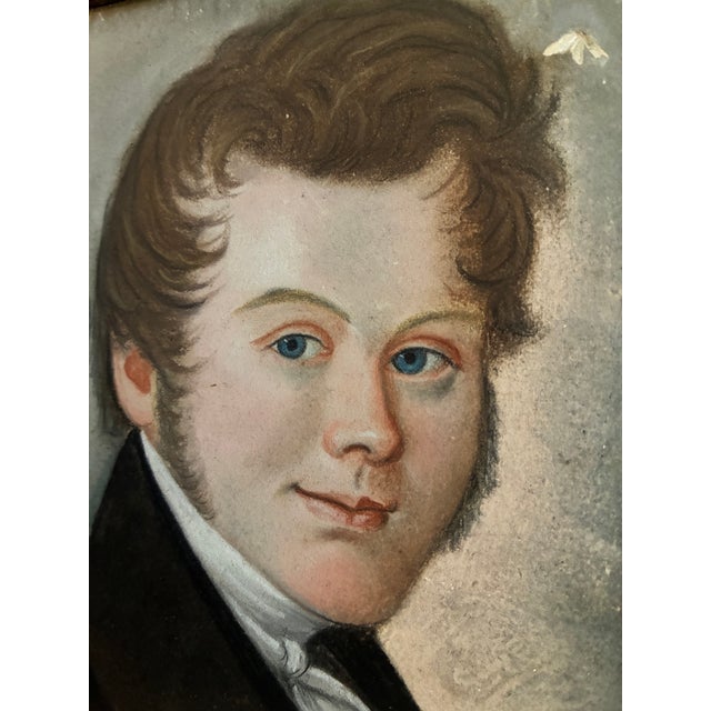 This antique pastel portrait of a gentleman, from around 1830, shows a young man with vivid blue eyes and softly curled...