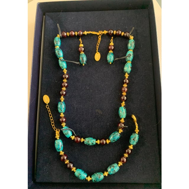 An elegant vintage Stauer jewelry set showcasing richly colored chrysocolla stone beads, accented with deep garnet-tone...
