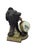 Decorative table clock featuring a patinated bronze lion sculpture, holding the spherical clock in its jaws. The clock...