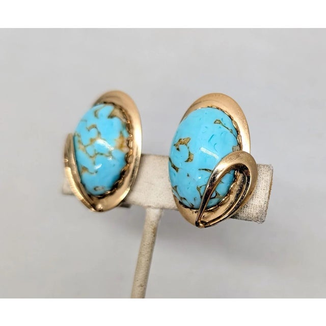 1950s oval goldtone cabochon faux-turquoise with loop decoration clip earrings. Marked "NAPIER PAT. PEND." on the clips....
