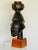 A carved wooden head with vessel. Attributed to the Guro people of Ivory Coast. Mounted on a later Walnut display plinth.