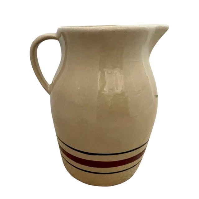 The Robinson Ransbottom Blue Red Stripe 3 Quart Stoneware Pitcher is a vintage piece of pottery handcrafted in Roseville,...