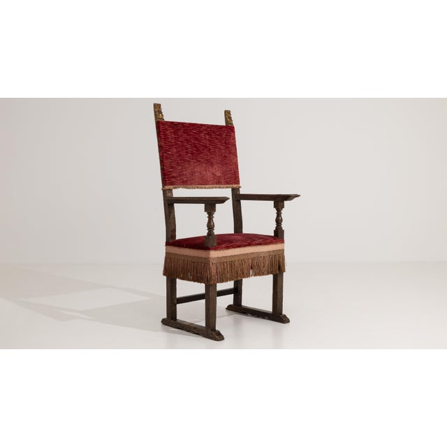 A Renaissance-style throne chair featuring a high back and carved wooden structure. The design emphasizes verticality and...