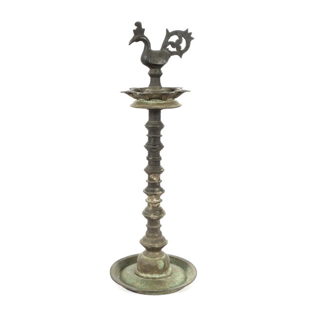 A traditional South Asian or South Indian oil lamp (often referred to as *Samai*, *Nilavilakku*, or *Kuthu Vilakku*) made...