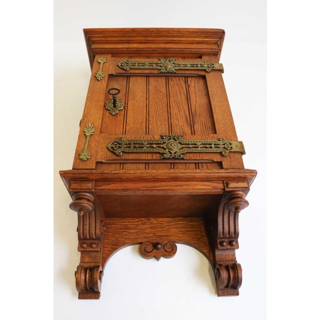 This finely crafted Arts & Crafts wall cabinet dates from the early 1900s and is made from solid European oak. The piece...