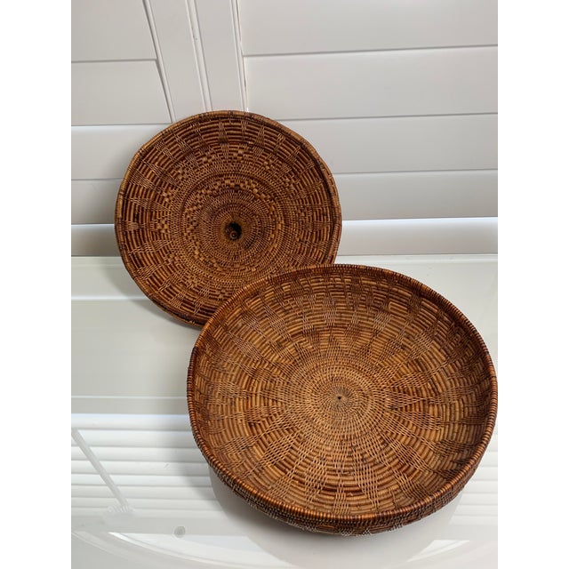 There are objects that earn their beauty over time, and this is one of them. A handwoven lidded basket of East African...