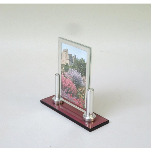 A rare and extraordinary picture frame in the strict design language of Art Deco with a base made of rose -colored glass...