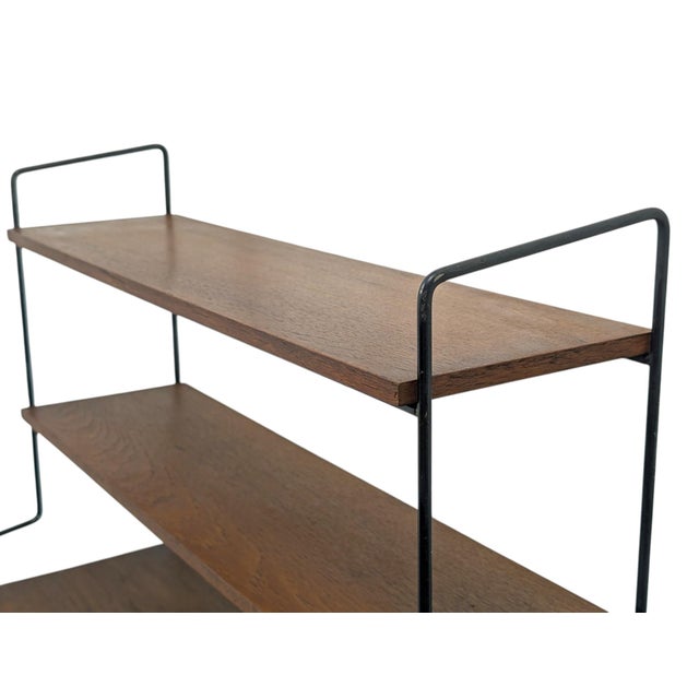 This freestanding Swedish bookcase is a refined example of Scandinavian Midcentury Modern design, dating back to the late...