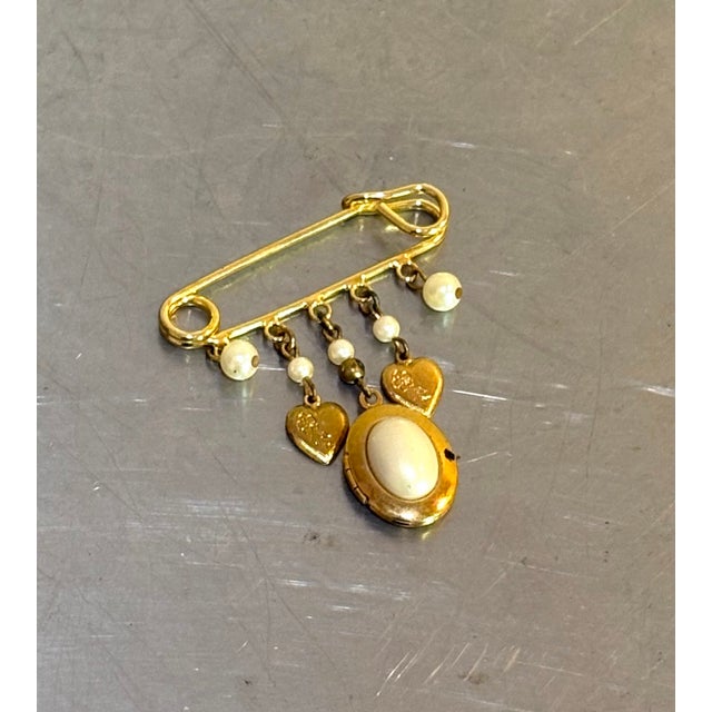 1960s-70s gold tone/faux pearl dangly safety pin locket brooch. Excellent condition.