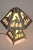 A dramatic and sculptural Mission style shaped form Native American Indian "End of the Trail" panel relief slag glass lamp...