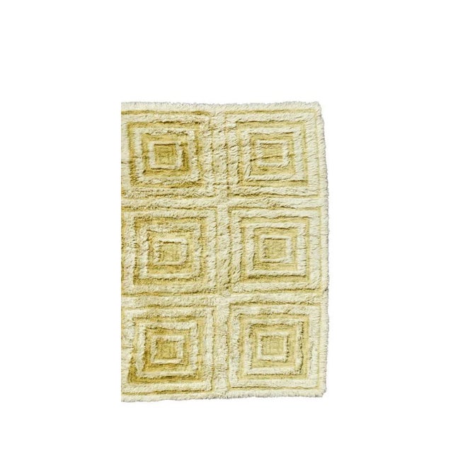 1970's Scandinavian green wool geometric design shag wall tapestry. The tapestry is woven with subtle green tones ranging...
