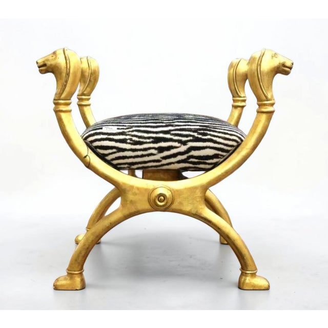Striking Italian Egyptian Revival curule chair dating to the 1970s–1980s, distinguished by an expressive sculptural frame...