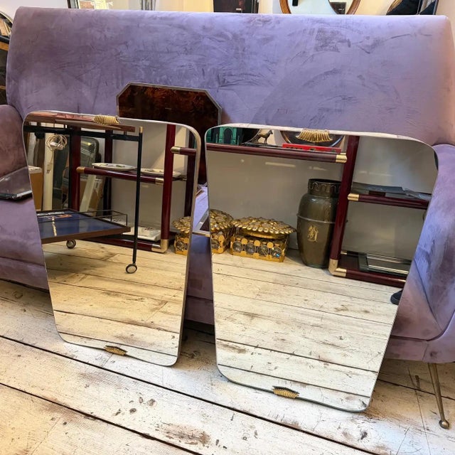 A stunning pair of Mid-century Modern wall mirrors in the highly sought-after Gio Ponti Style, dating from the 1950s....