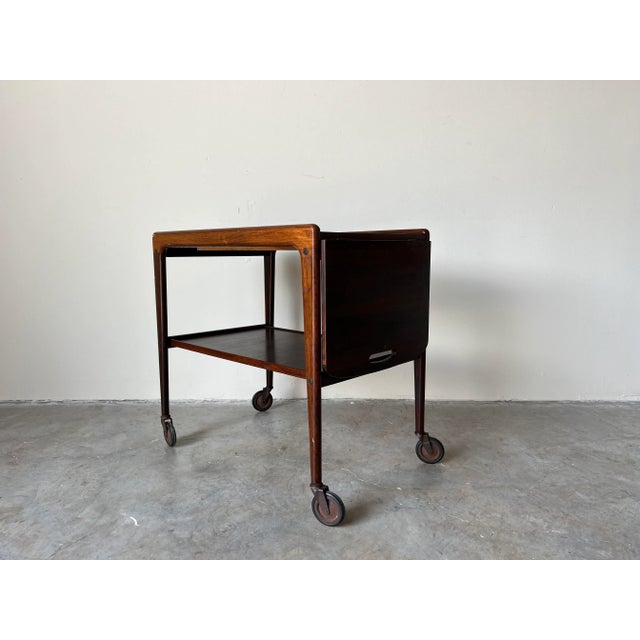 Hinged side table and serving trolley in teak and laminate top. The trolley was designed by Yngve Ekström for Kallemo. The...