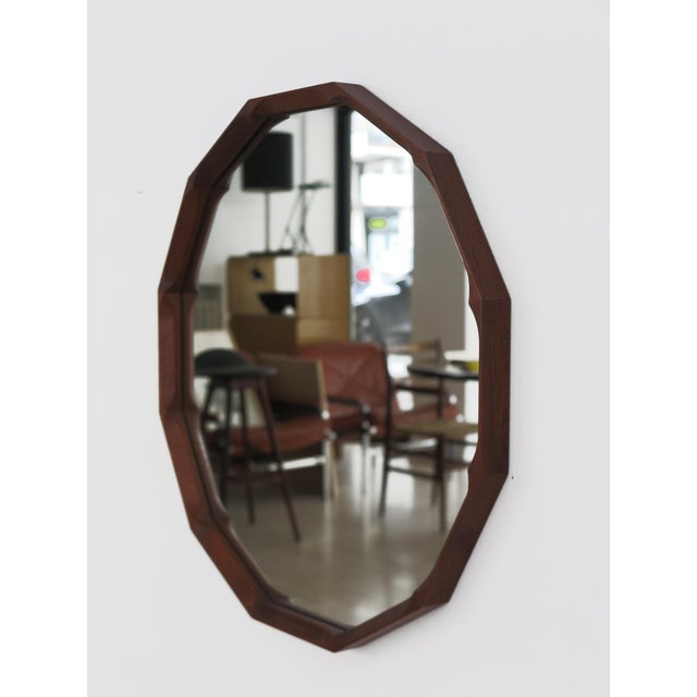 Italian dodecagonal wall mirror designed by Dino Cavalli and produced by Tredici with finely crafted solid wood frame and...