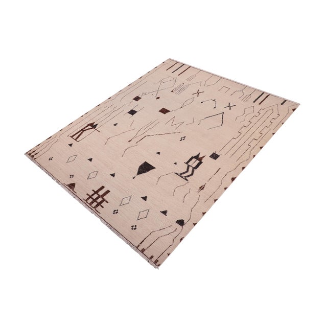 Elevate your interior with this hand-knotted high-low wool area rug, designed to bring depth and dimension to any room....