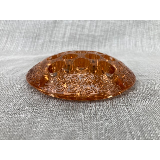 Antique depression glass flower pin frog in a pretty peachy-brown color with a raised design along the outer top edge. No...