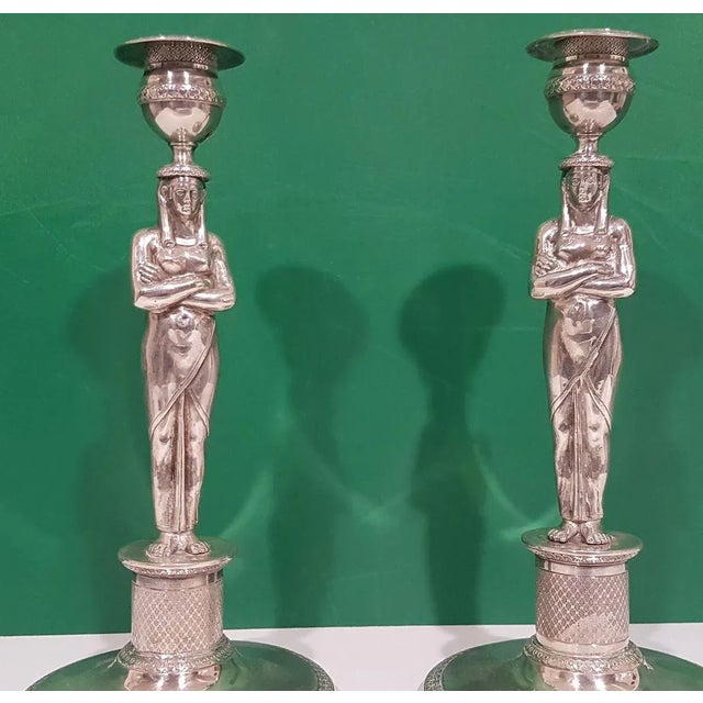 Body with Egyptian telamon on a silver base, Italian manufacture. Circular bae illustrated with Greek style bands and...