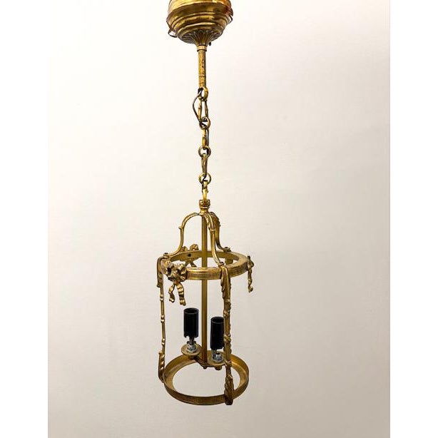 This darling two-light birdcage lantern features ornate detailing and a whimsical design. Three vertical posts are each...