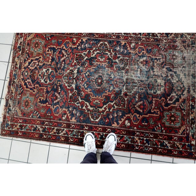 A character-rich handmade antique Persian Hamadan rug, dating from the 1920s, featuring a bold geometric medallion design...