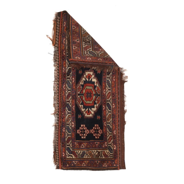 This authentic Central Persian nomadic weaving shows an ecru Tekke Turkmen-style gul on a navy ground with small, stepped...