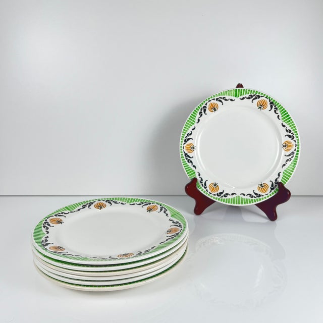 Set of 7 Sarreguemines "Maroussia" dessert plates, early 20th century White, green, orange and black Dimensions: Diameter:...