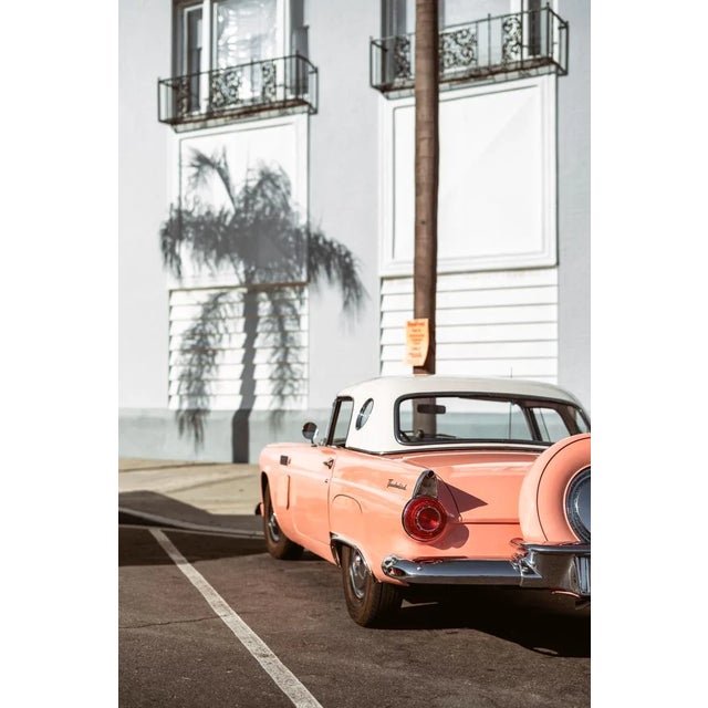 A 1950s pink Ford Thunderbird and the shadow outline of palm tree create a perfect nostalgic California afternoon....