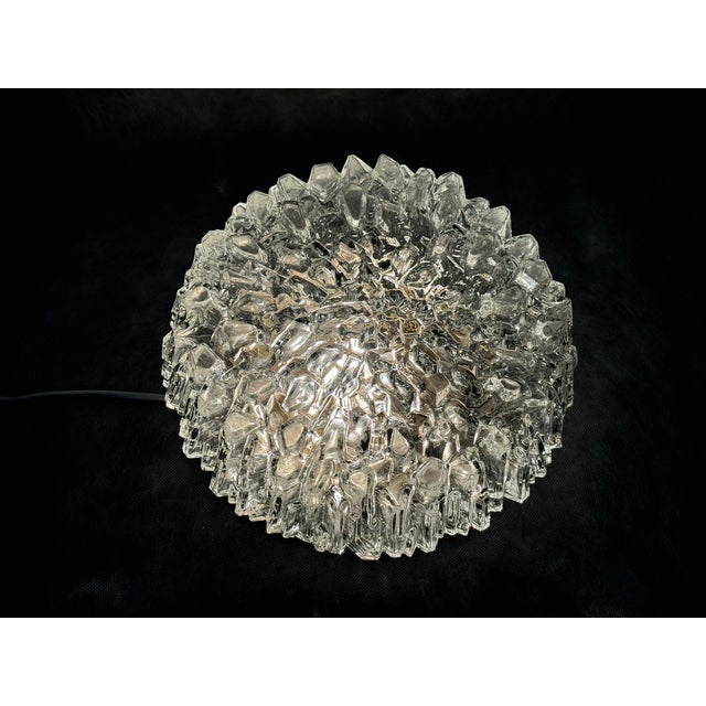 Striking vintage flush mount ceiling light made of thick, clear textured glass with an ice-like crystalline structure....