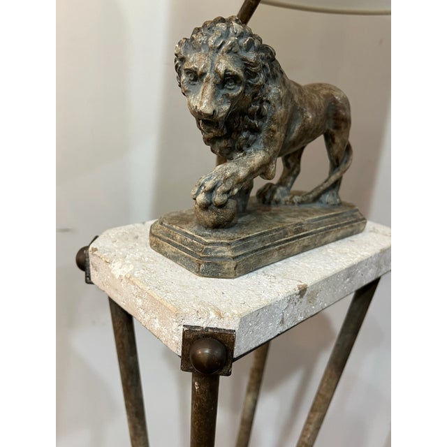 Elegant Medici floor lamp made of iron and marble with lion motif, attributed to Maitland-Smith 1980's vintage This is a...