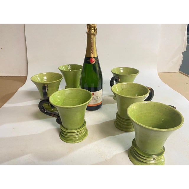 Set of 6 Ceramic Cups, Handmade in France Circa 1970. The handles of the cup are in a brown Color and the cups are in a...