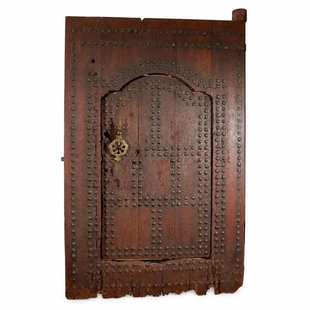 Monumental 19th-century Moroccan Hispano-Moresque studded wood doorway, handcrafted in Marrakech. This impressive antique...