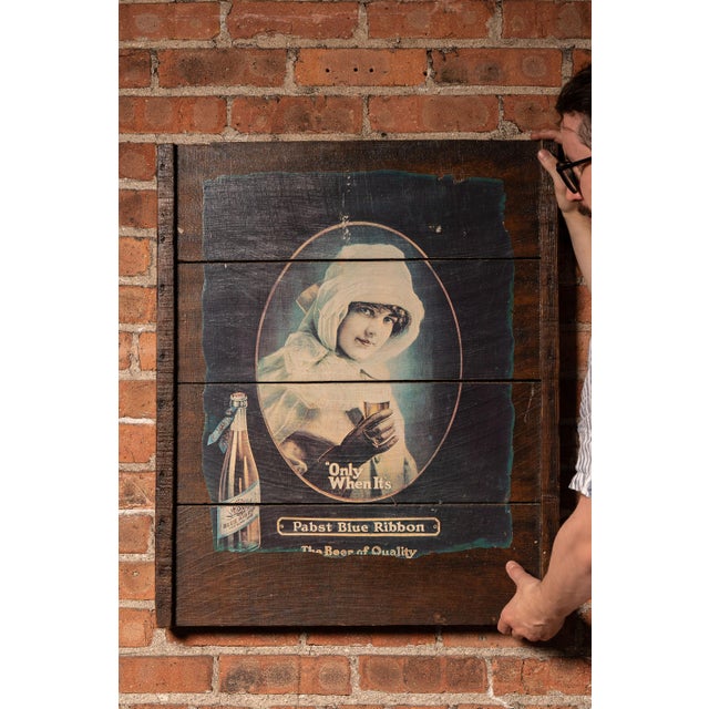 Decorative advertising panel constructed from a 1970s Pabst Blue Ribbon reproduction print mounted across a series of...