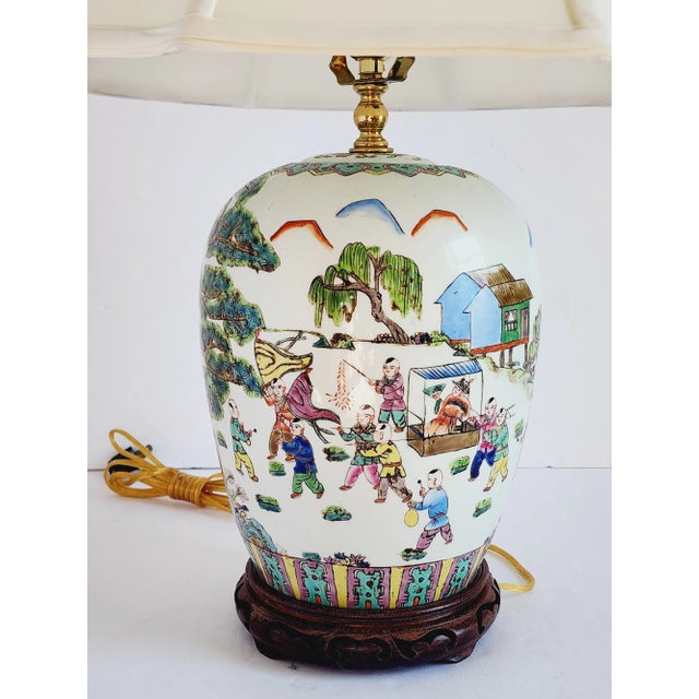 Antique Chinese Export Famille Rose porcelain table lamp made from a ginger jar. Featuring a scenery of a celebration in a...