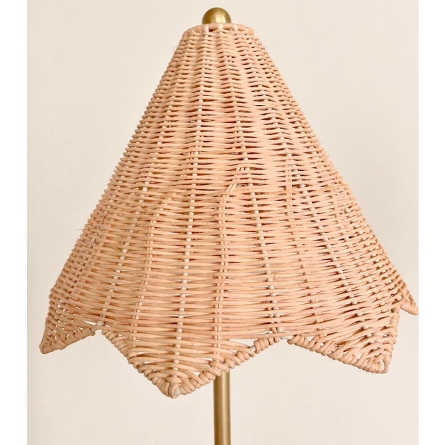 A matching pair of Lillian August Parasol table lamps featuring woven rattan shades with graceful scalloped edges. Slender...