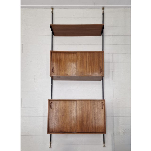 Large and highly elegant 13 piece Italian modular wall unit dating from the 1960s, executed in warm teak veneered wood...