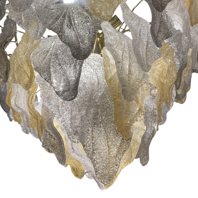 What makes this piece unique is that it features Murano glass pieces in three different colors: gold, gray, and clear,...