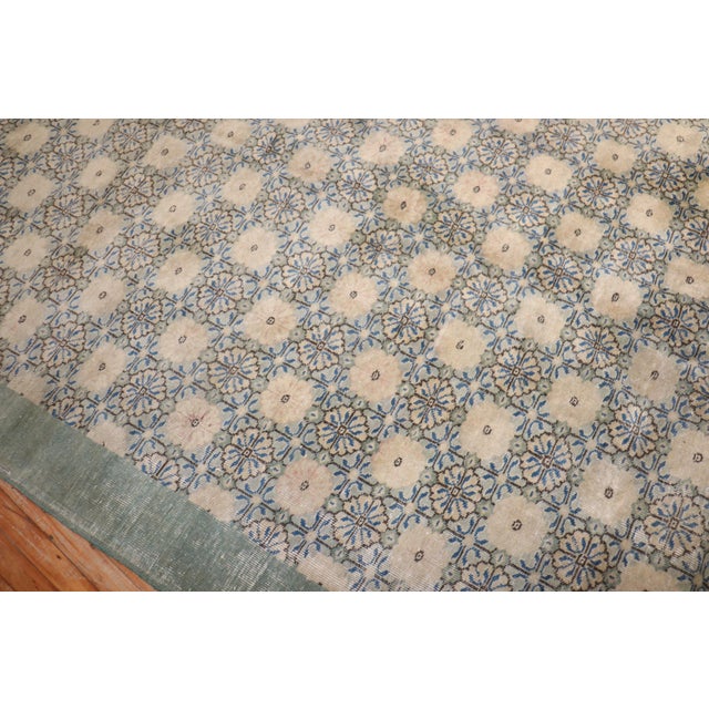 Mid-20th century Turkish Deco rug with a floral design in green, blue, and ivory Measures: 6'10''x 9'8''.
